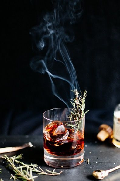 Smoked mocktail with rosemary garnish and rising smoke